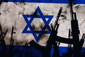 Several automatic rifles raised up on the background of the Israeli flag