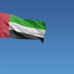 Flag of United Arab Emirates in front of a clear blue sky